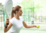 A female padel player about to serve